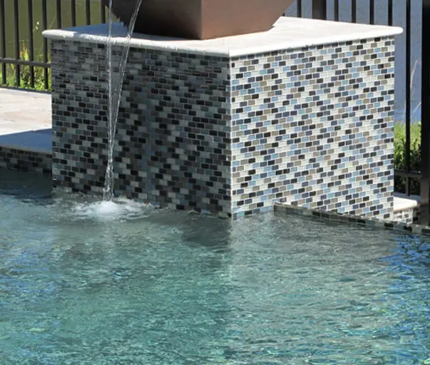 Swimming pool tile and spillway